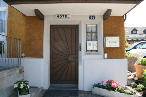 a door to a hotel with a sign on it at Hotel Glärnisch Hof in Horgen