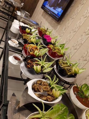 a buffet with many plates of food on a table at City Rose Hotel Suites in Amman