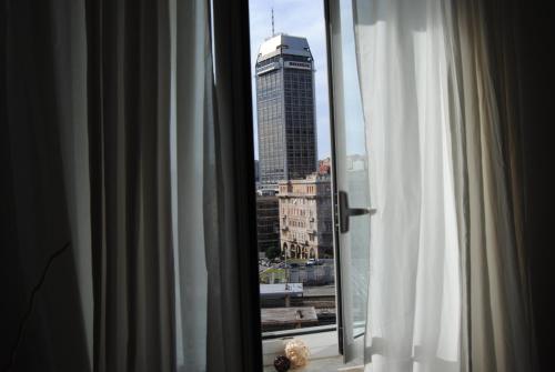 a window with a view of a city at Bb Tube in Genova