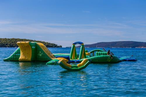 two inflatable water slides in the water at Hotel Medena in Trogir