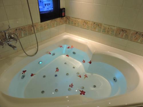 a bath tub with stars in it in a bathroom at Edinburgh Motel in Anping