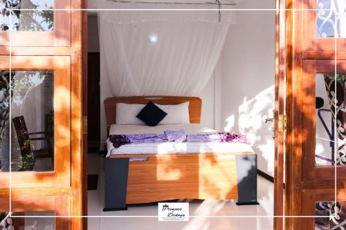 a bedroom with a bed in a room with a window at Princess of Dickoya Homestay in Hatton