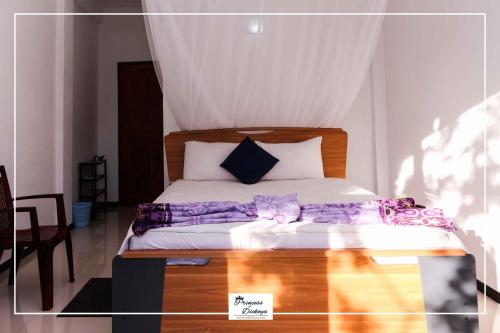 a bedroom with a bed with purple sheets on it at Princess of Dickoya Homestay in Hatton