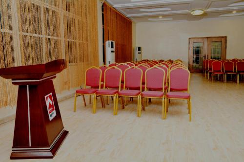 a group of chairs in a room with a podium at Sweet Spirit Hotel and Suites Danag - Port Harcourt in Port Harcourt