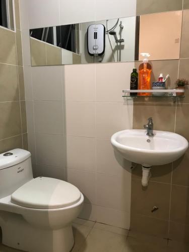a bathroom with a toilet and a sink at House Of Nostalgia in Lumut