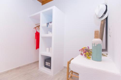 a room with white walls and a white shelf at Salinus Beachfront Private Pool Villas in Plaka