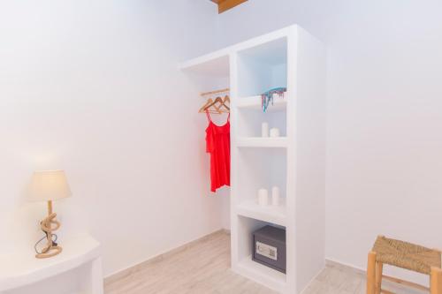 a room with a white book shelf and a table at Salinus Beachfront Private Pool Villas in Plaka