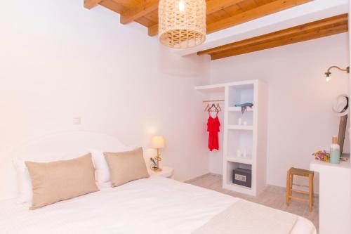 a bedroom with a white bed in a room at Salinus Beachfront Private Pool Villas in Plaka