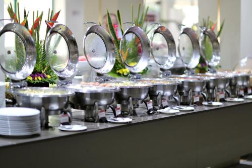 a buffet line with pots and pans of food at Sweet Spirit Hotel and Suites Danag - Port Harcourt in Port Harcourt