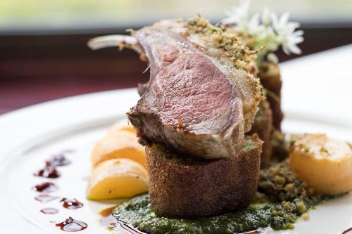 a piece of meat sitting on a white plate at Loch Melfort Hotel in Ardfern