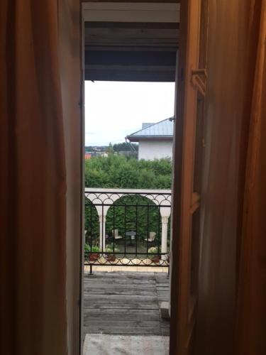 an open door with a view of a balcony at Bellavilla in Vilnius