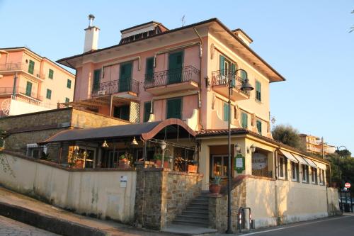 a building with a restaurant on the side of a street at Locanda Miranda in Tellaro