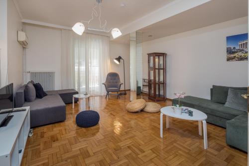 a living room with a couch and a table at Elite Downtown Central 5th Floor Apartment in Athens