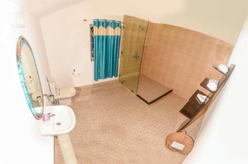 a bathroom with a shower and a sink at The Village Resort Palolem in Palolem