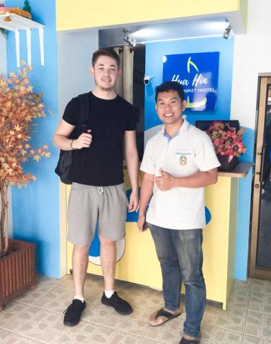 two men standing next to each other in a room at HuaHin Night Market Hostel in Hua Hin
