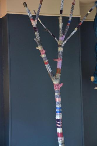 a vase with a tree made out of sticks at Chambres d'Hôtes & SPA Le Chat Chez Qui j'Habite in Saint-Aubin-sur-Mer