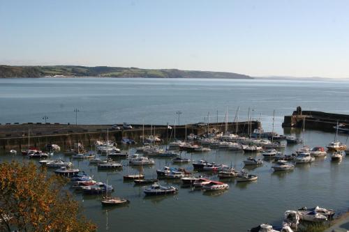 a bunch of boats are docked in a harbor at Nythfa Guest House in Saundersfoot