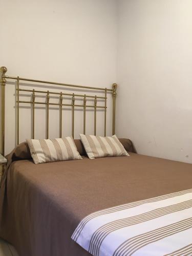 a bed with two pillows on top of it at Hotel Marítimo Urban in Alicante