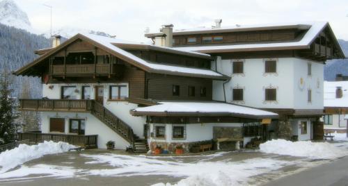 a large building with snow in front of it at Residence La Pineta in Padola