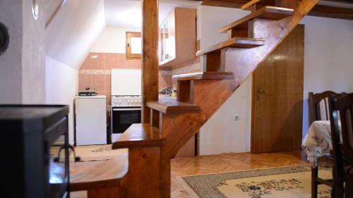 a kitchen with a wooden staircase in a house at Holiday Home Mrljes in Rast