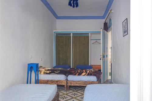 En eller flere senge i et værelse på Hostal La Joya