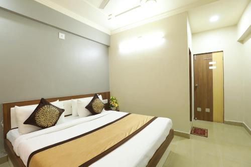 a bedroom with a large bed in a room at Hotel Loyal Residency in Jamnagar