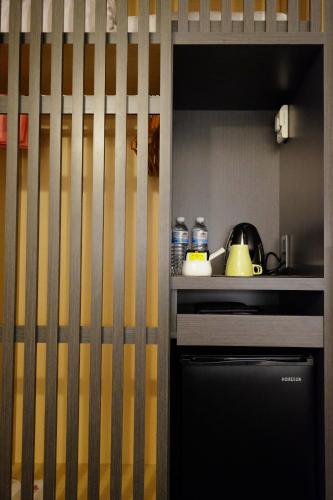 a small kitchen with a counter and a stove at Dynasty Hotel in Tainan