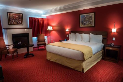 a hotel room with a large bed and a fireplace at Skyline Hotel and Casino in Las Vegas