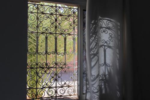 an open window with a view of a garden at Riad Hiba in Foum Zguid