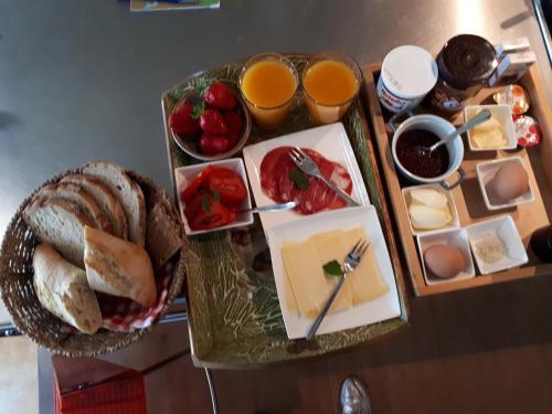 a table with a tray of cheese and other foods at Voorhuis in Eelde-Paterswolde