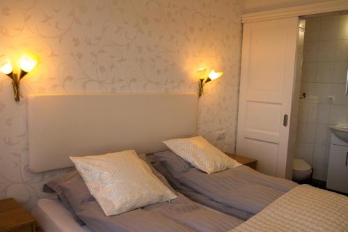 a bedroom with a bed with two pillows on it at Finna Hótel in Hólmavík