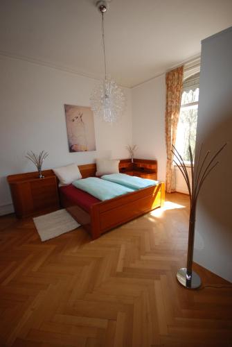 ein Schlafzimmer mit einem Bett und einer Vase auf dem Boden in der Unterkunft Appartements in zentraler Lage in Tübingen