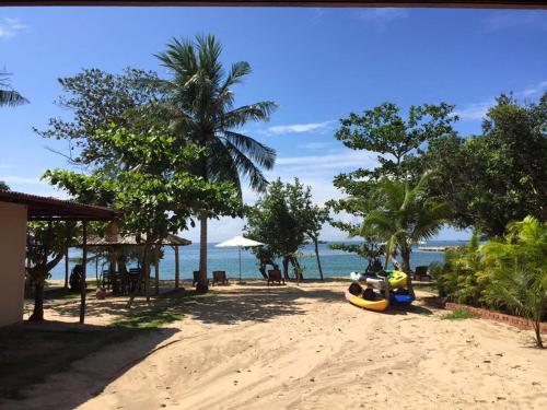 a motorcycle parked on a sandy beach near the ocean at Gold Sand Beach Bungalow in Phu Quoc