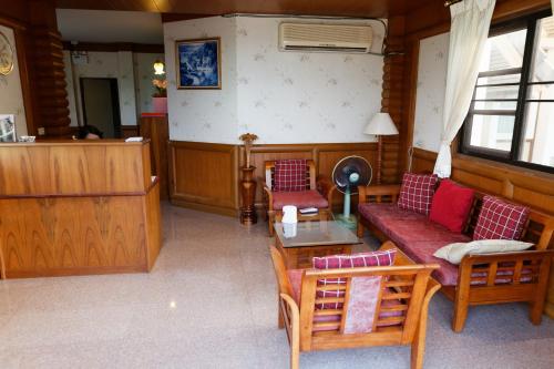 a living room with a couch and a table at TaLeKaew Resort SHA in Phitsanulok