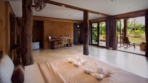 a bedroom with a bed with white pillows on it at Bambuh Boutique Homestay in Ban Den
