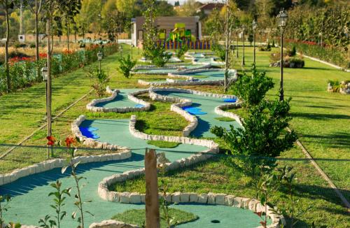 a garden with a row of water pathways at Mantar Spa Hotel in Marikostinovo