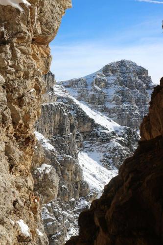 a view of a rocky mountain with snow on it at B&B Casabasoti in Valli del Pasubio