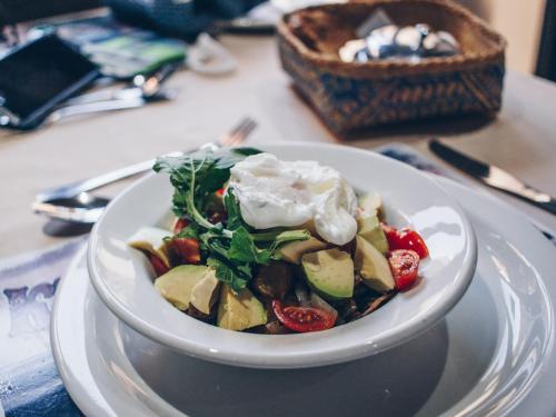 a white plate with a salad on a table at African Perfection 1 in Jeffreys Bay