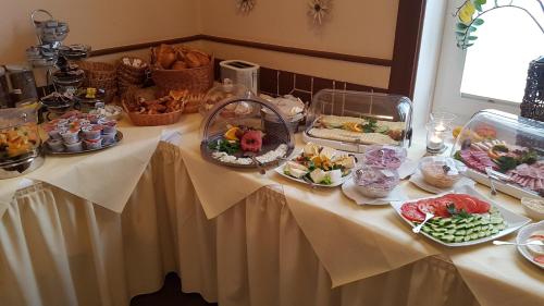 a table with a buffet of food on it at Hotel-Restaurant Holsteiner Hof in Geesthacht