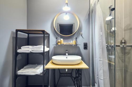 a bathroom with a sink and a mirror at Kaleidoscope on Nevskiy in Saint Petersburg