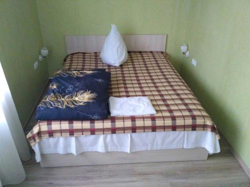 a small bed with two pillows on it at Apartment on the World in Cherkasy