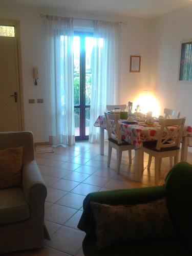 a living room with a table and chairs and a light at Bed And Breakfast Catherina in Ponsacco