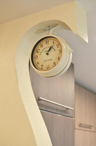 a clock hanging on the wall in a room at Tomsona Apartment Riga Center in Rīga