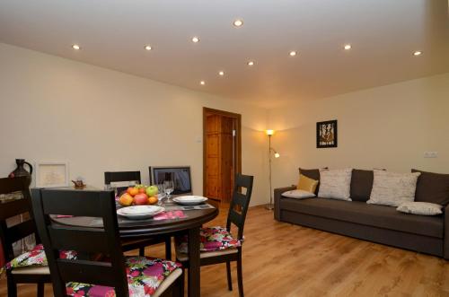 a living room with a table and a couch at Tomsona Apartment Riga Center in Riga