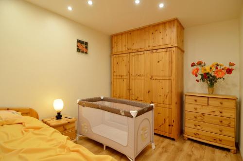 a bedroom with a bed and a dresser and aoir at Tomsona Apartment Riga Center in Riga