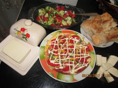 a table with a plate of food and a salad at Cherqe Guest House in Sighnaghi