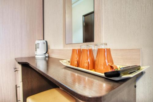 a counter with glasses and a tray of juice at Hotel Rich in Vnukovo