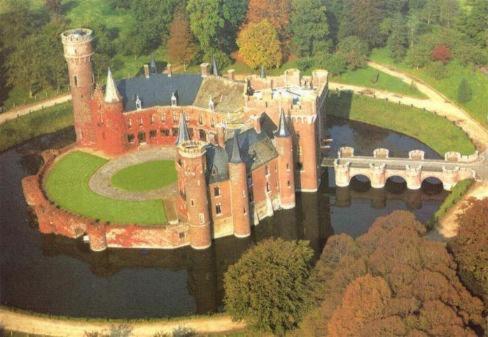 an aerial view of a castle on a lake at De Bosrand in Ichtegem