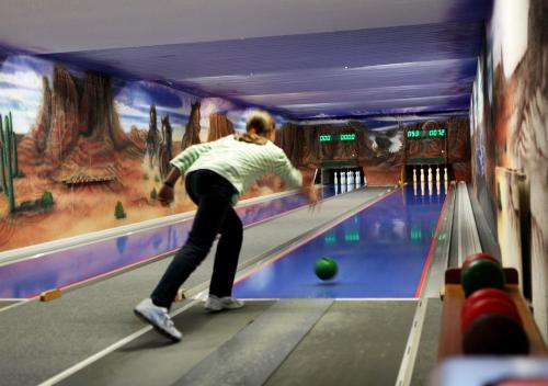 a woman playing a game of pins bowling at Hotel Sonneck in Schwäbisch Hall