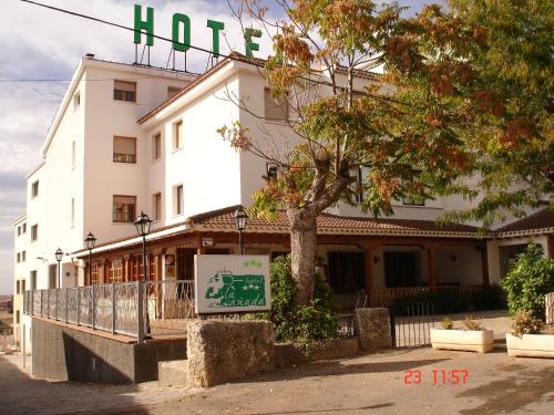 a building with a sign in front of it at La Cañada in Horche